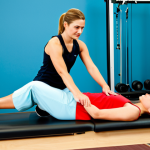 Physical Therapy Session**

A physical therapist guiding a female patient in a modern rehabilitation center, performing a leg exercise. The patient is fully clothed in athletic wear, appropriate attire, with a supportive expression. The therapist is also fully clothed in professional attire. The scene includes exercise equipment and a bright, clean background. Perfect anatomy, natural proportions, well-formed hands, proper finger count, safe for work, appropriate content, fully clothed, professional, modest, family-friendly.

**
